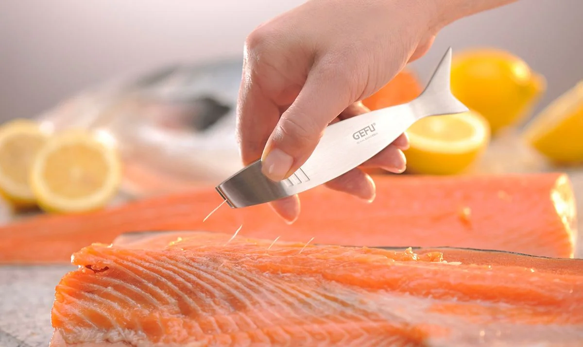 Originalfoto: GEFU TOLA Fischgrätenpinzette beim Herausziehen einer feinen Gräte aus einem Lachsfilet